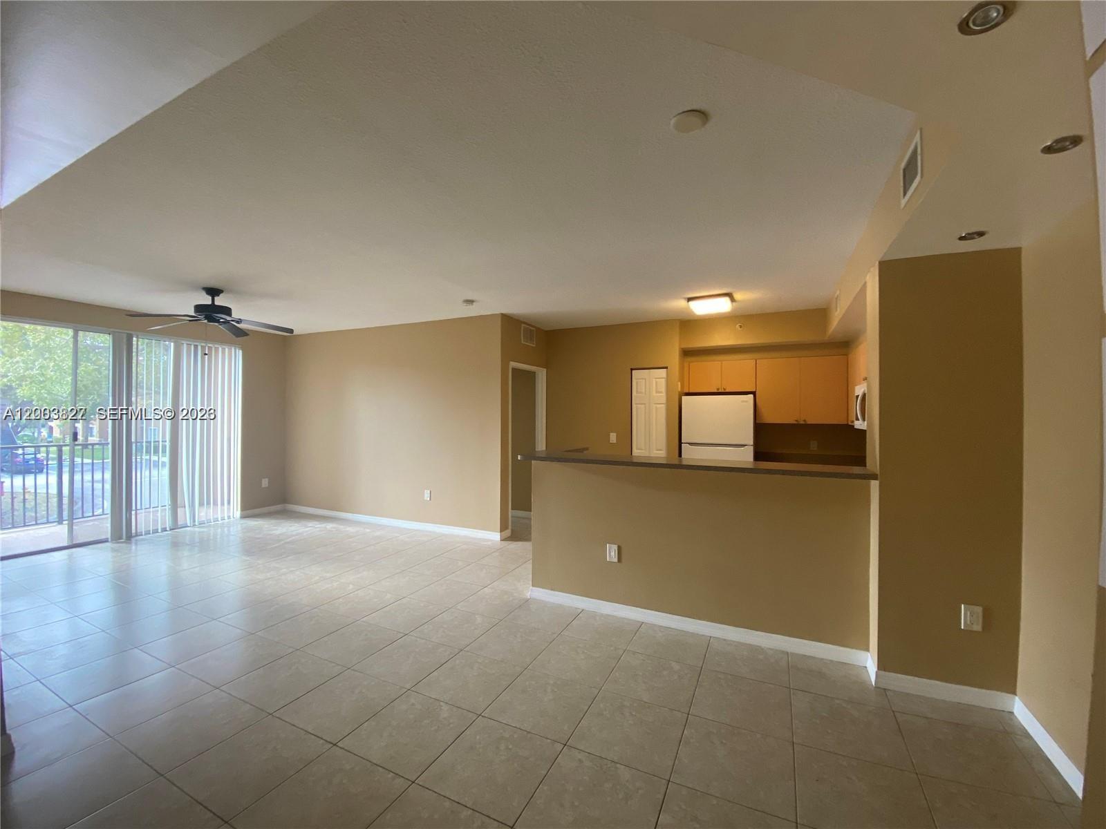 8060 North Nob Hill Road, Unit 203 Tamarac, FL 33321 - Photo 7 of 69 a view of a livingroom with an empty space