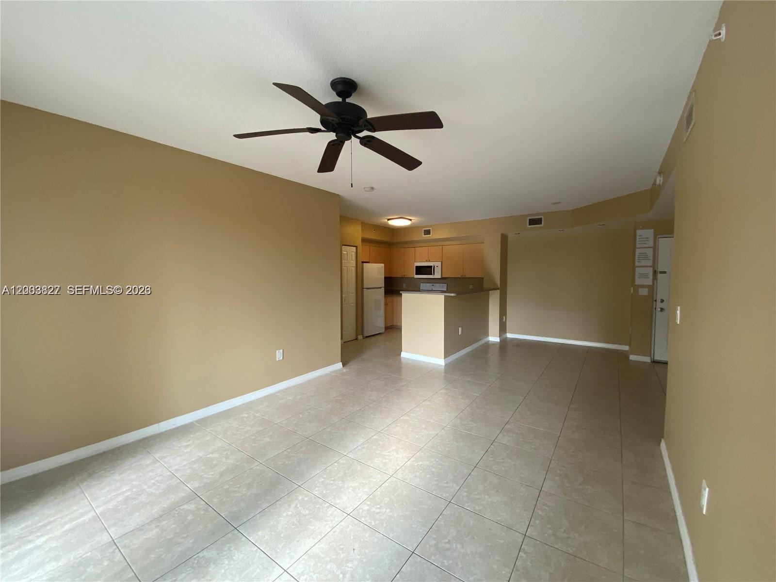 8060 North Nob Hill Road, Unit 203 Tamarac, FL 33321 - Photo 8 of 69 a view of a livingroom with a ceiling fan and entryway