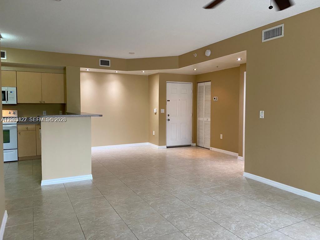 8060 North Nob Hill Road, Unit 203 Tamarac, FL 33321 - Photo 10 of 69 a view of a kitchen with a sink and a refrigerator