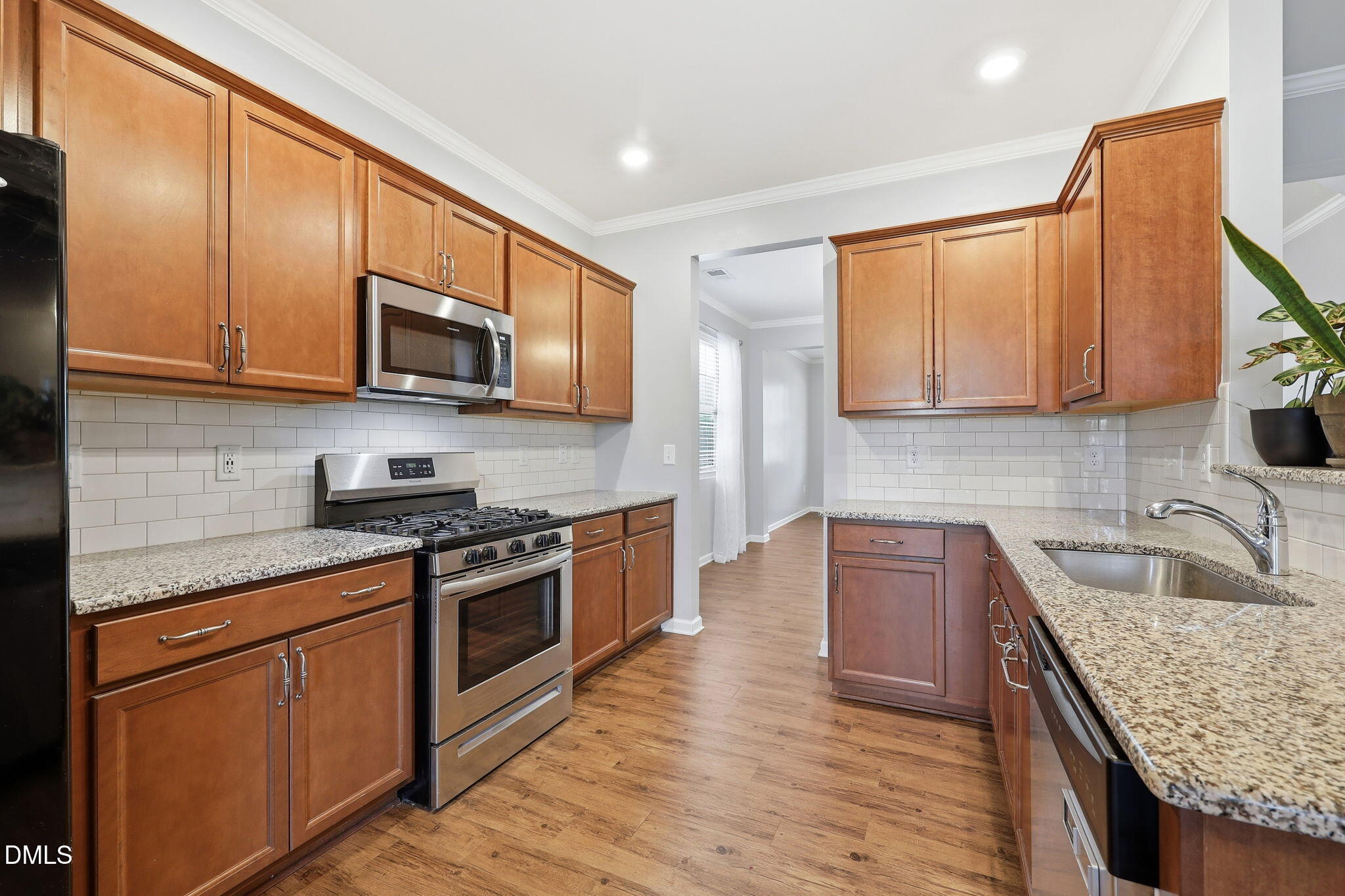1808 Austin Rdg Parkway Wake Forest, NC 27587 - Photo 14 of 57 a kitchen with stainless steel appliances granite countertop a sink stove microwave and cabinets