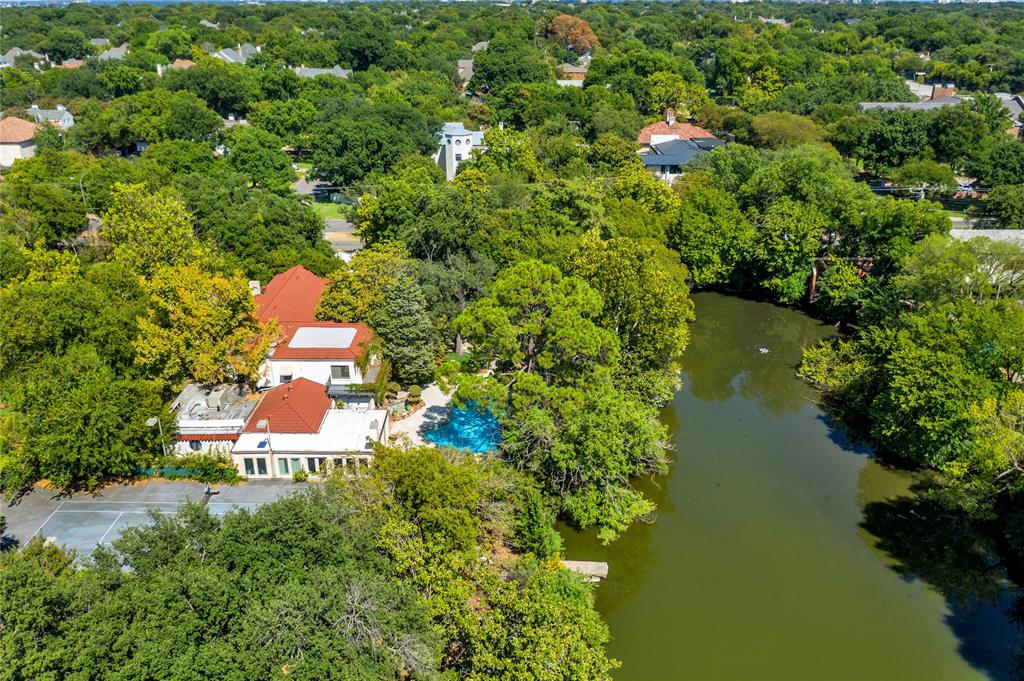 9909 Preston Road Dallas, TX 75230 - Photo 1 of 22 an aerial view of a house with a yard and lake view
