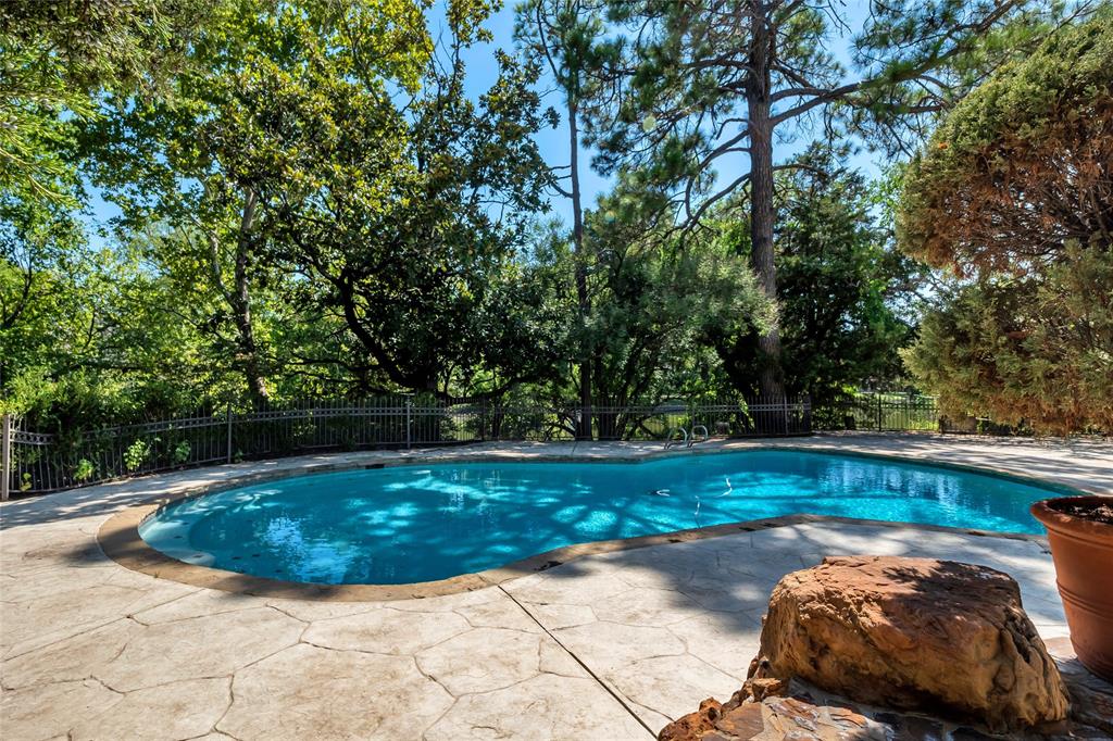 9909 Preston Road Dallas, TX 75230 - Photo 19 of 22 a view of a backyard with large trees
