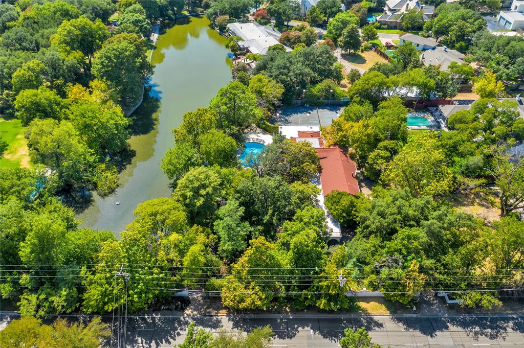 9909 Preston Road Dallas, TX 75230 - Photo 7 of 22 a view of a lake with large trees