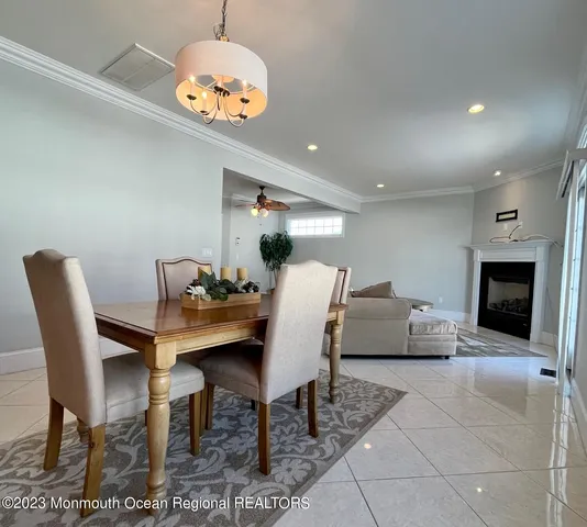 a dining room with furniture and a chandelier