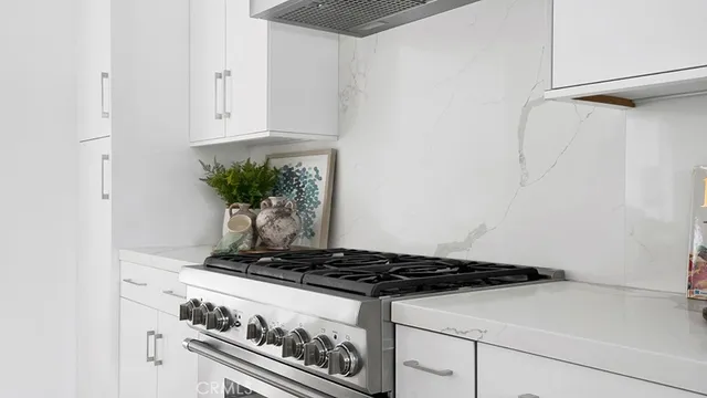 a stove top oven sitting inside of a kitchen