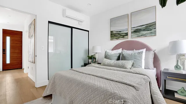 a bedroom with a bed and a large mirror