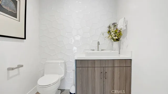 a bathroom with a sink vanity and toilet