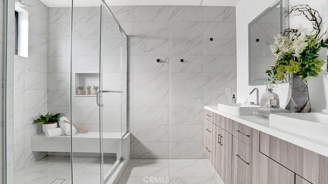 a bathroom with a granite countertop sink a toilet and shower