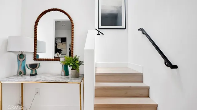 a view of hall with wooden floor and potted plant