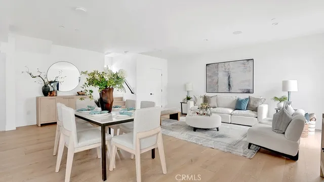 a living room with furniture potted plant and white walls