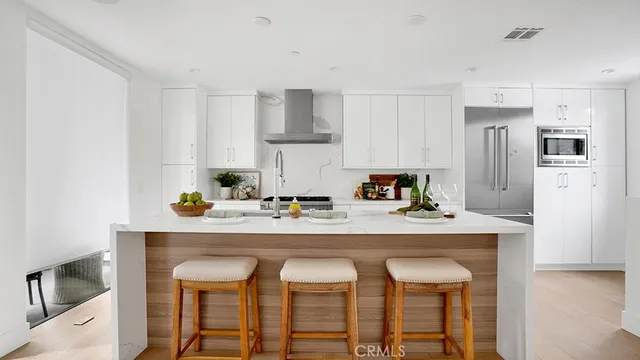 a kitchen with stainless steel appliances a sink and cabinets