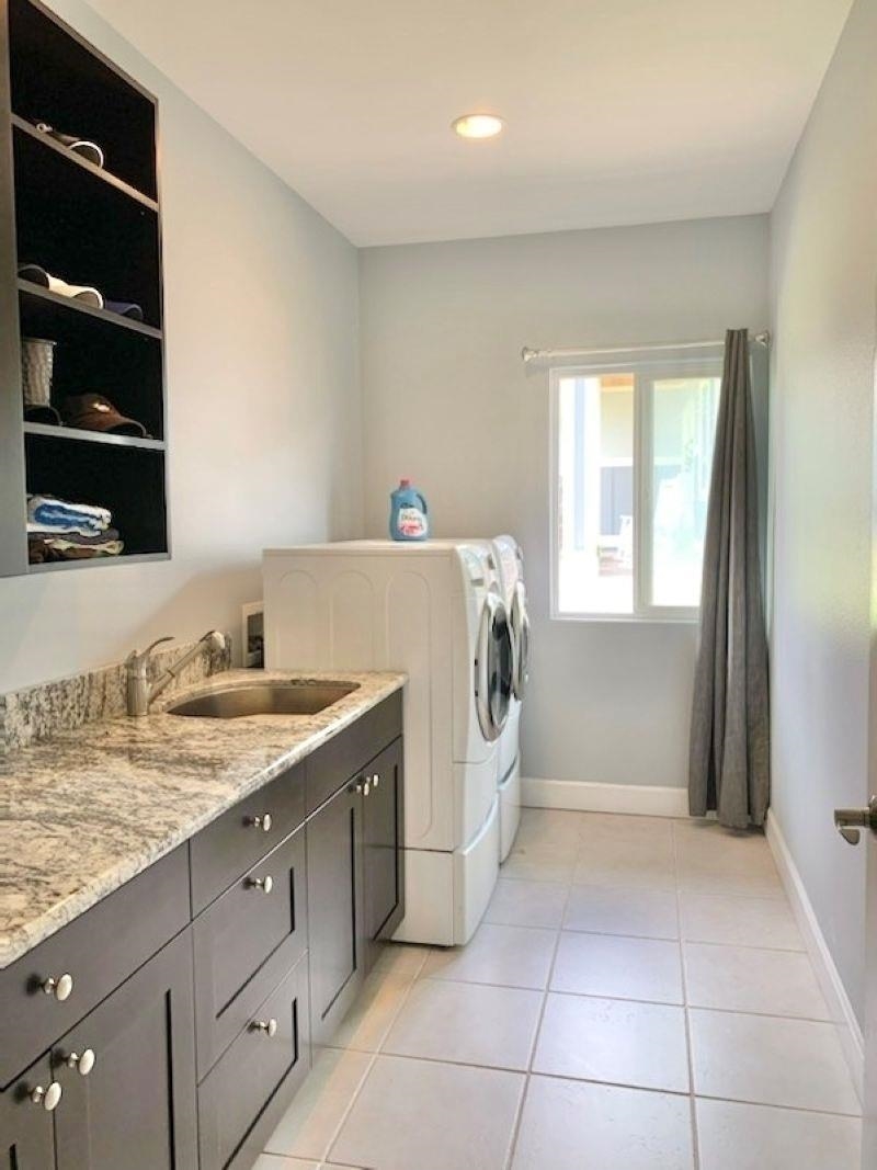 80 Koani Loop Wailuku, HI 96793 - Photo 17 of 18 a utility room with cabinets washer and dryer