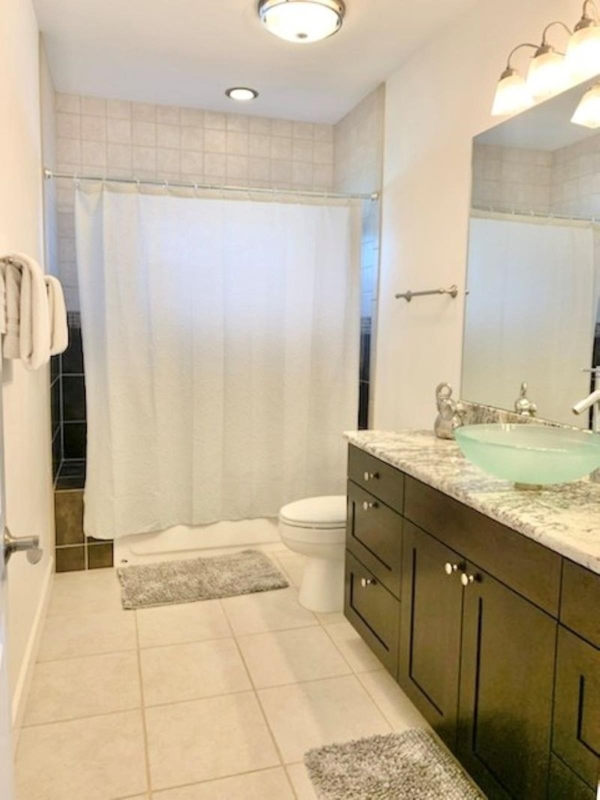 80 Koani Loop Wailuku, HI 96793 - Photo 18 of 18 a bathroom with a granite countertop sink toilet and shower