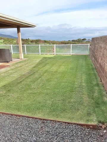 a view of a swimming pool and a yard