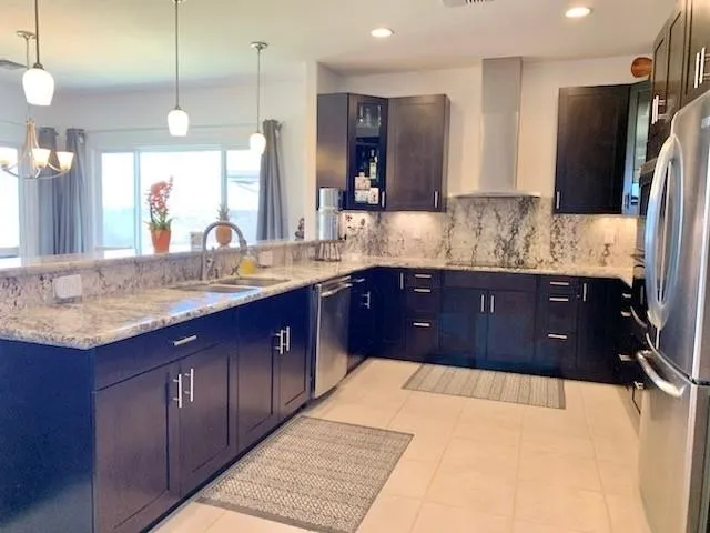 a kitchen with a sink a refrigerator and cabinets