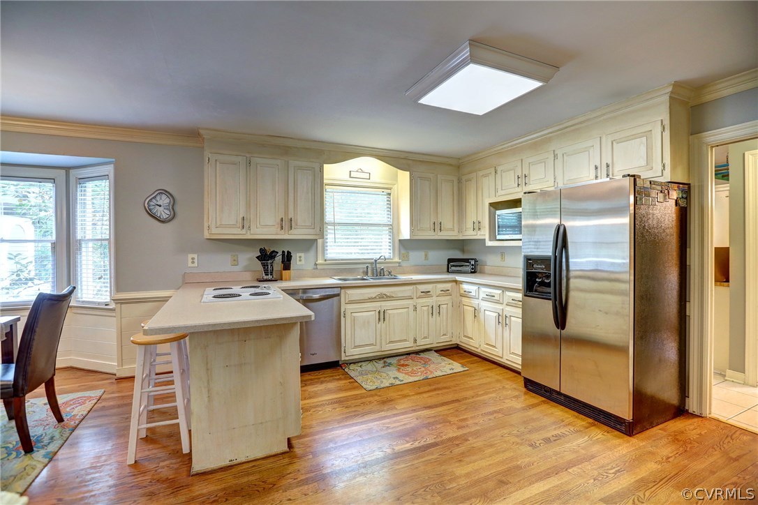 5810 Deep Forest Road North Chesterfield, VA 23237 - Photo 20 of 32 a kitchen with a refrigerator a sink dishwasher a stove and a dining table with wooden floor
