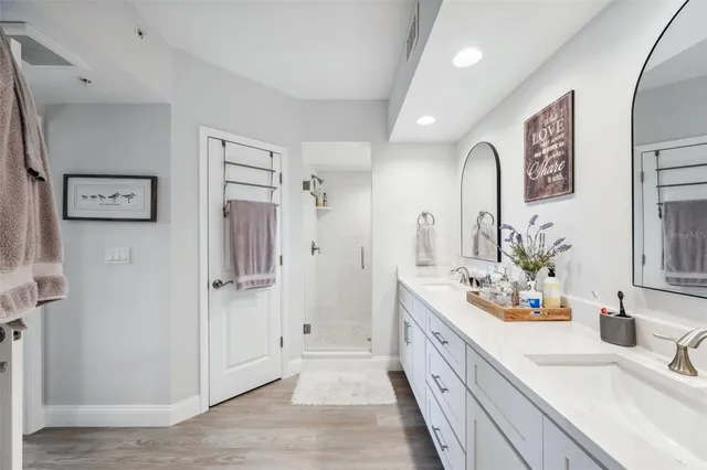 a spacious bathroom with a double vanity sink mirror and double