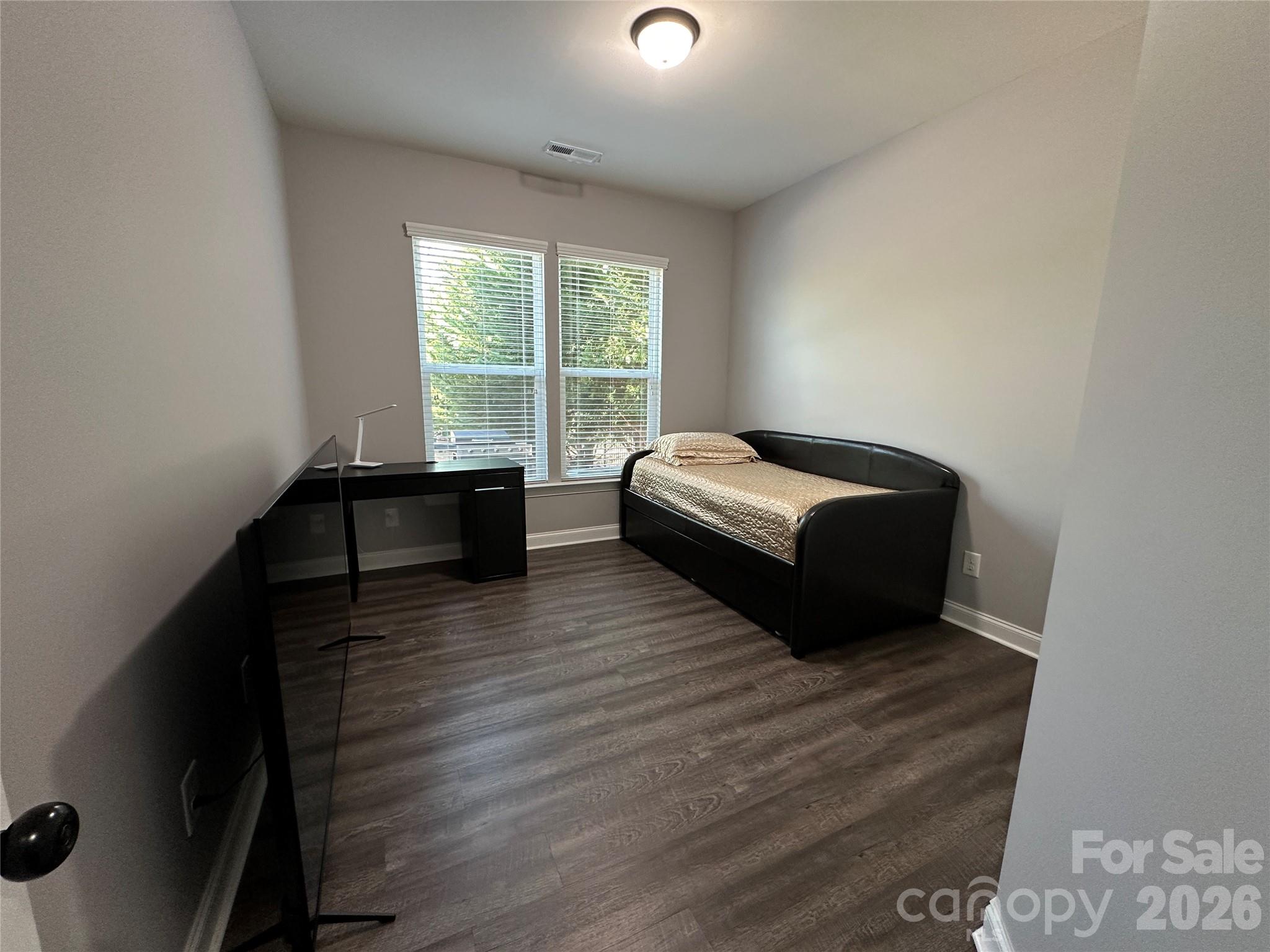 1004 Fallondale Road Waxhaw, NC 28173 - Photo 16 of 42 a spacious bedroom with a bed and wooden floor