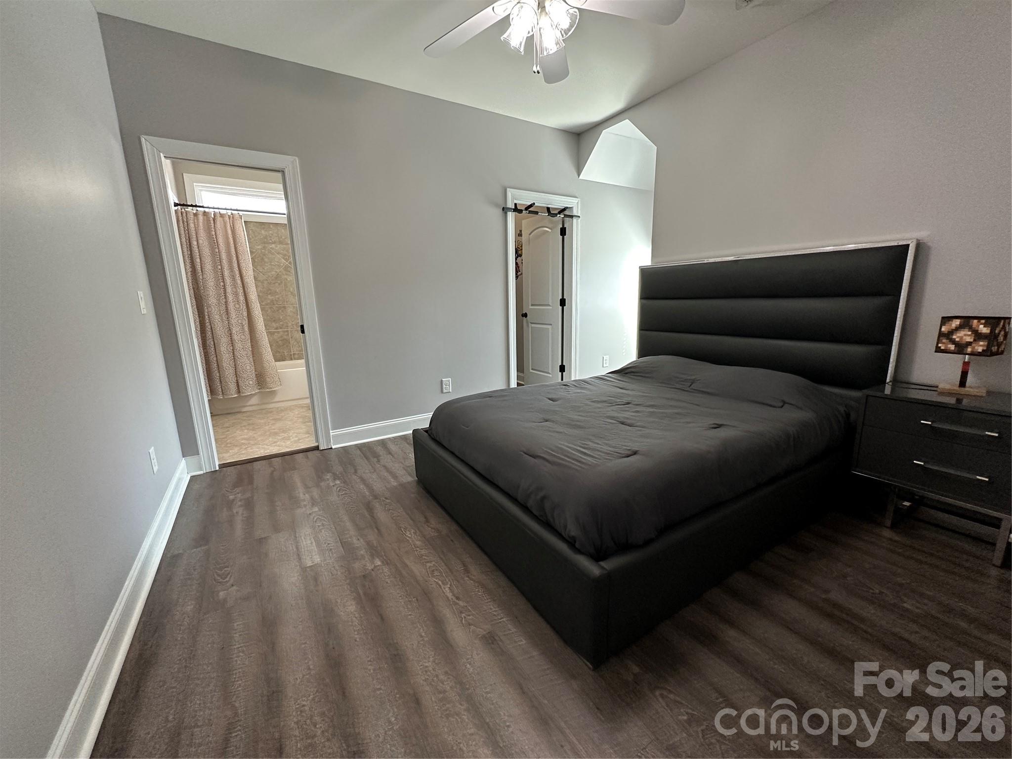 1004 Fallondale Road Waxhaw, NC 28173 - Photo 30 of 42 a living room with a bed furniture and a wooden floor