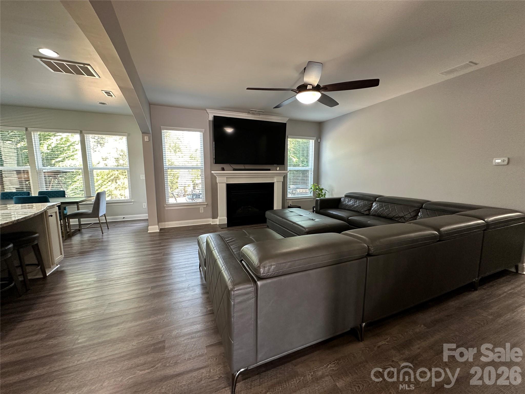 1004 Fallondale Road Waxhaw, NC 28173 - Photo 7 of 42 a living room with furniture a flat screen tv and a fireplace