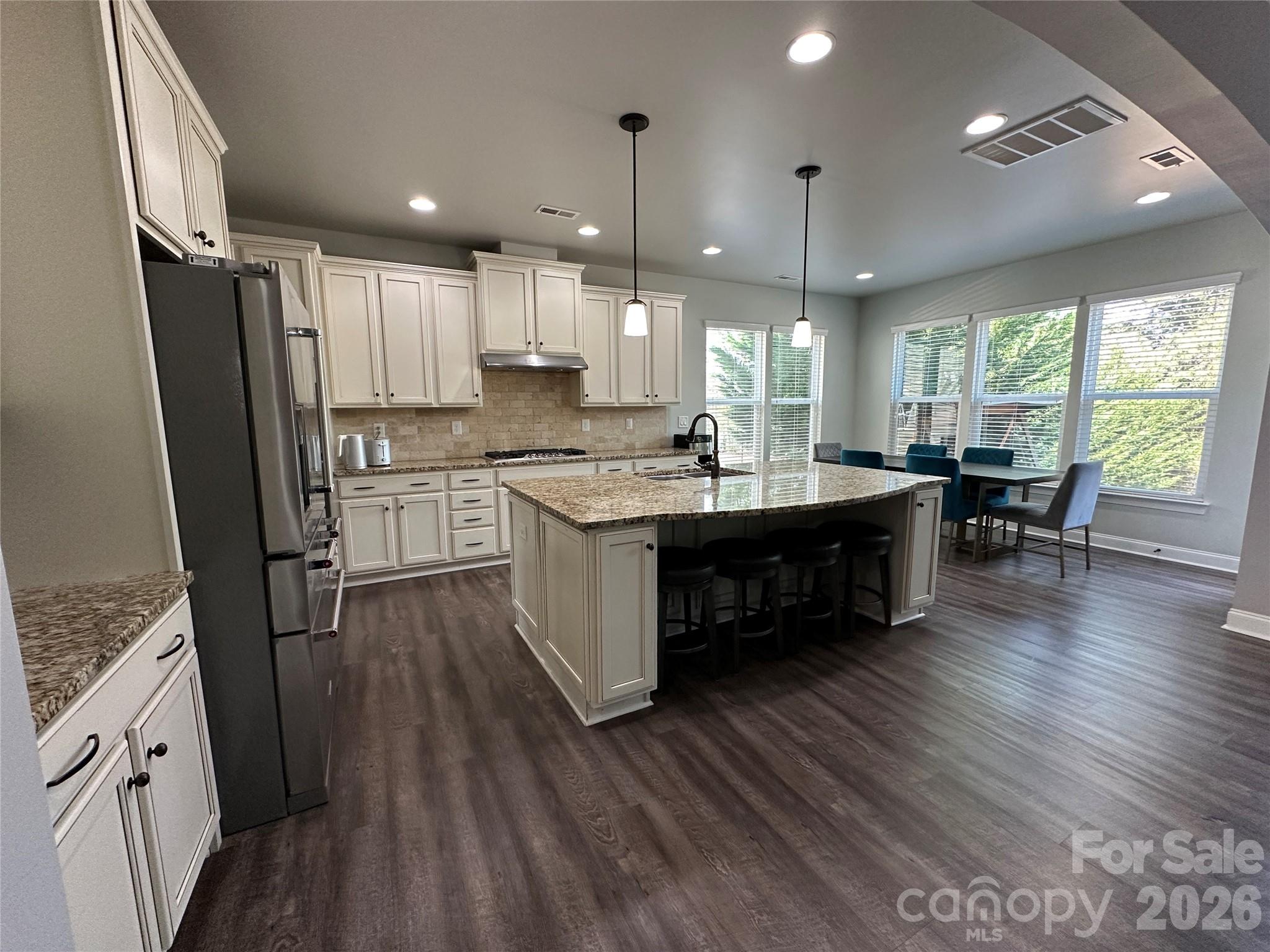 1004 Fallondale Road Waxhaw, NC 28173 - Photo 8 of 42 a kitchen with stainless steel appliances granite countertop wooden floors sink and stove