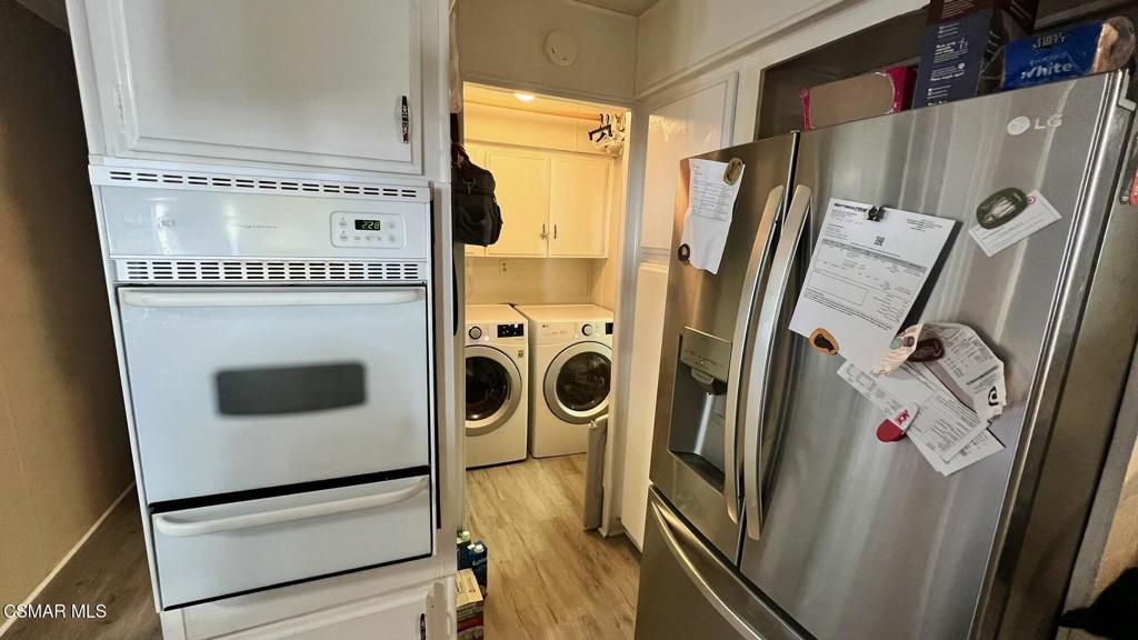 1550 Rory Lane, Unit 20 Simi Valley, CA 93063 - Photo 4 of 13 a utility room with wooden floor washer and dryer