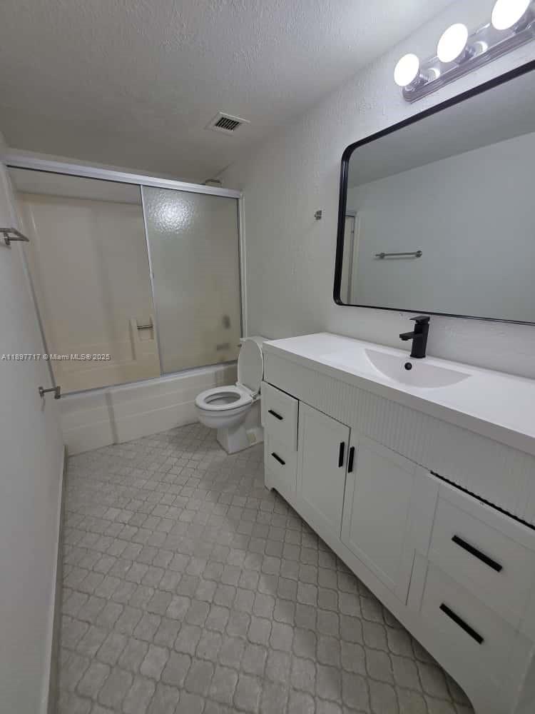 13499 Biscayne Boulevard, Unit 811 North Miami, FL 33181 - Photo 11 of 20 a spacious bathroom with a toilet sink and mirror