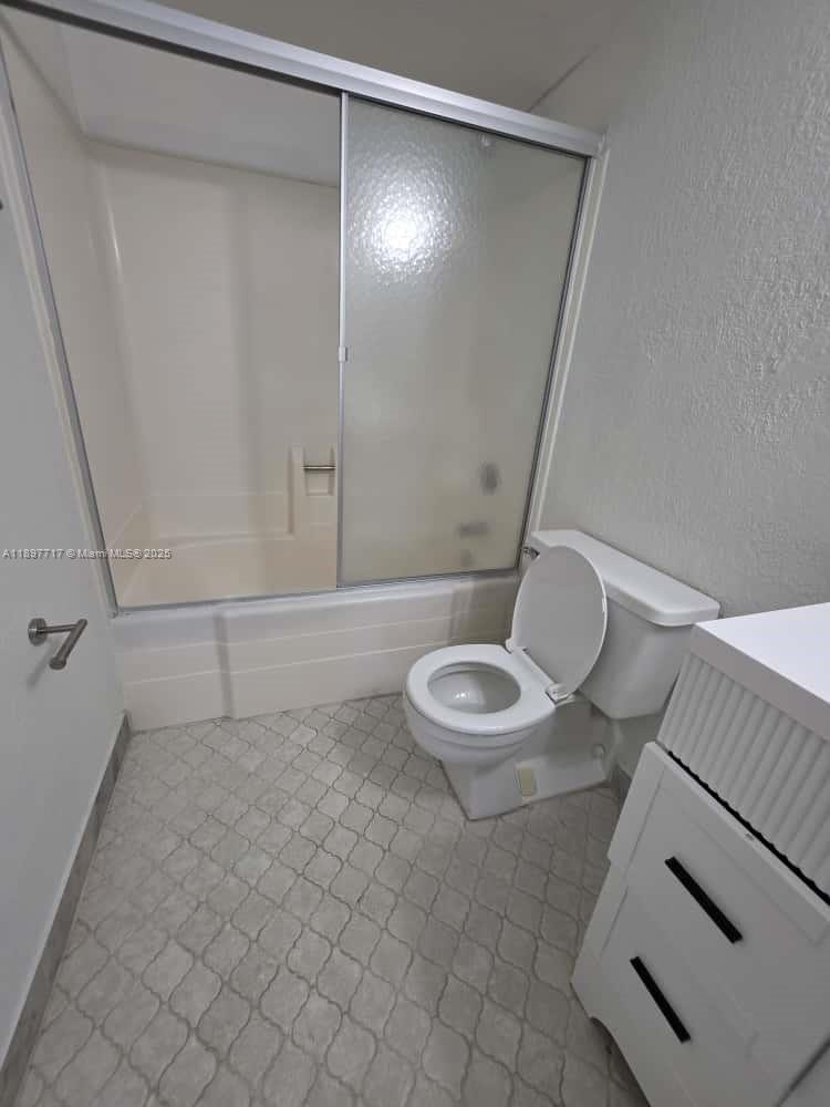 13499 Biscayne Boulevard, Unit 811 North Miami, FL 33181 - Photo 12 of 20 a bathroom with a sink a toilet and a mirror