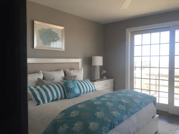 a bedroom with a large bed and a window