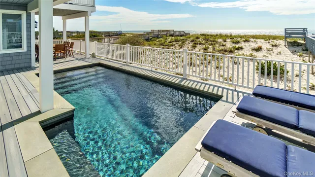 a view of roof deck with two chairs and wooden floor