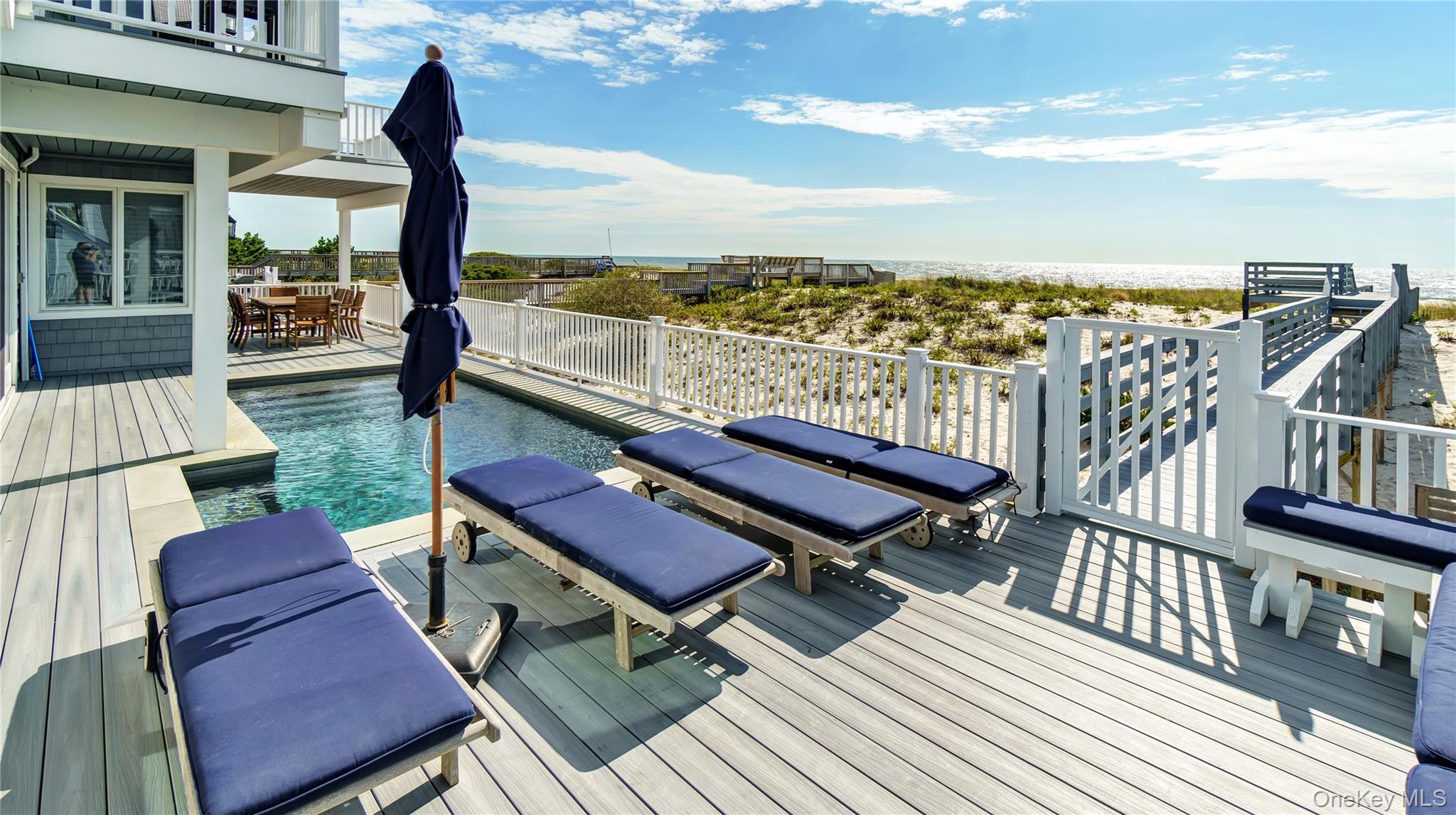939 Dune Road West Hampton Dunes, NY 11978 - Photo 14 of 21 a view of a chairs and table on the terrace