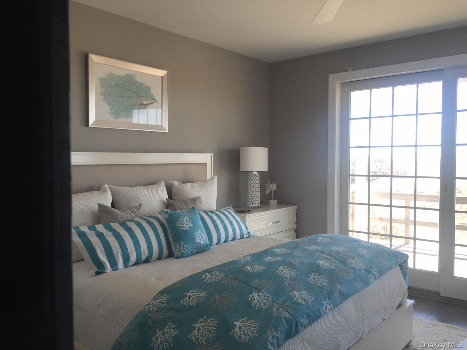 939 Dune Road West Hampton Dunes, NY 11978 - Photo 16 of 25 a bedroom with a large bed and a window