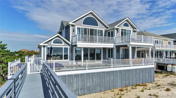 a front view of a house with a wooden deck