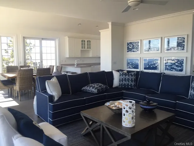 a living room with furniture potted plant and a window