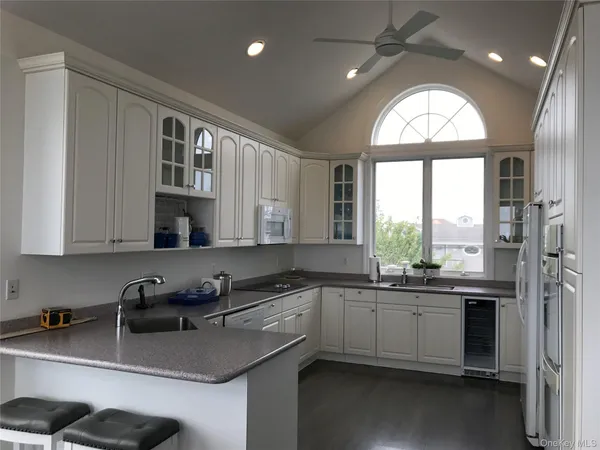 a kitchen with a sink a window and stainless steel appliances