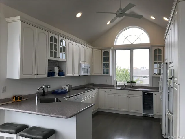 a kitchen with a sink a window and stainless steel appliances