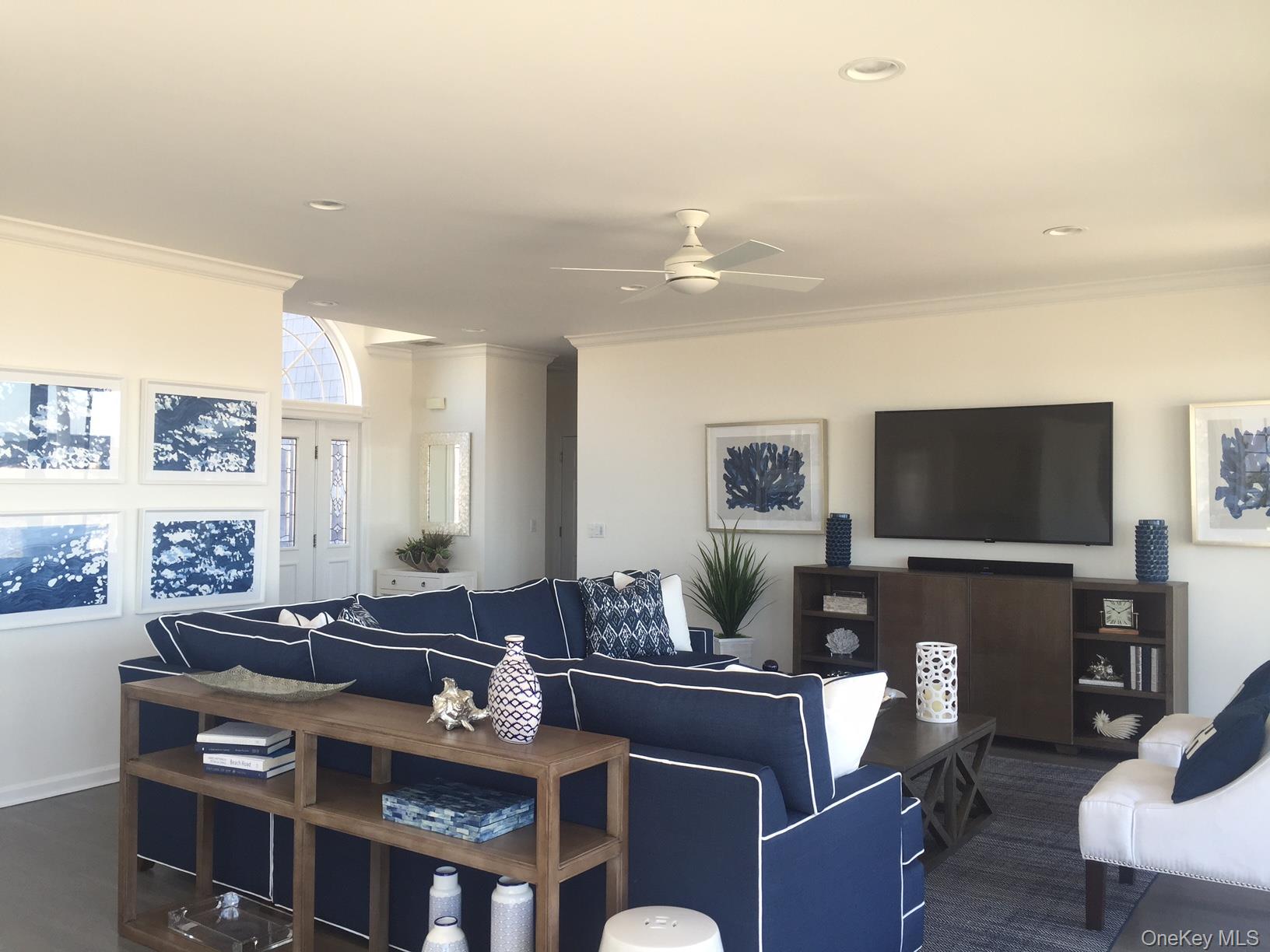 939 Dune Road West Hampton Dunes, NY 11978 - Photo 6 of 21 a living room with furniture a flat screen tv and kitchen view