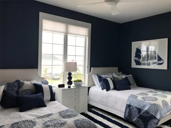 a bedroom with bed window and couch