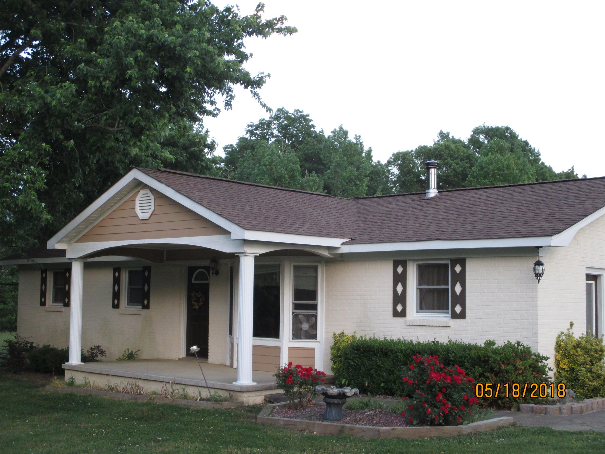 1089 Fall River Road Goodspring, TN 38460 - Photo 1 of 24 a front view of a house with garden