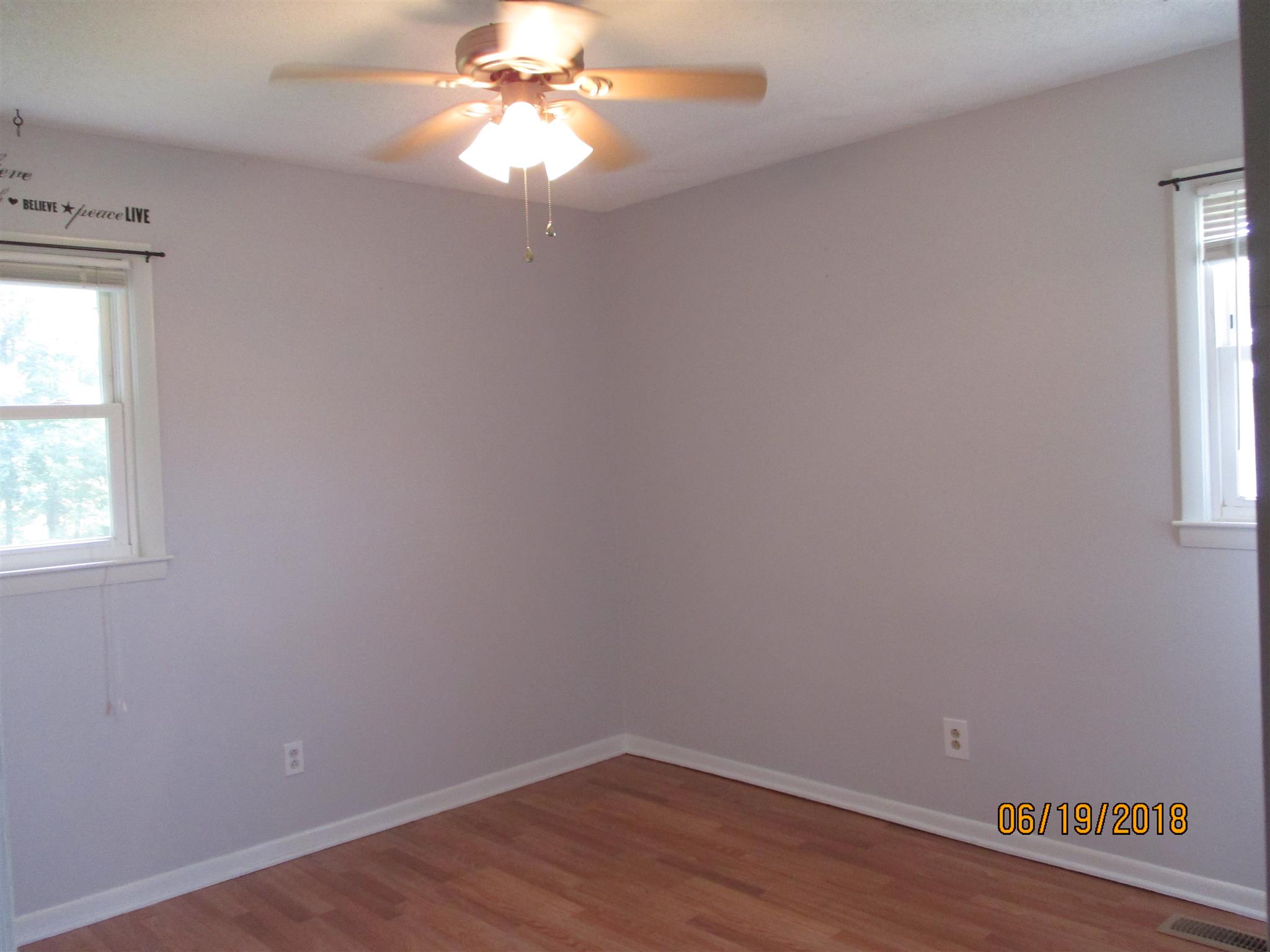 1089 Fall River Road Goodspring, TN 38460 - Photo 11 of 24 an empty room with wooden floor and windows