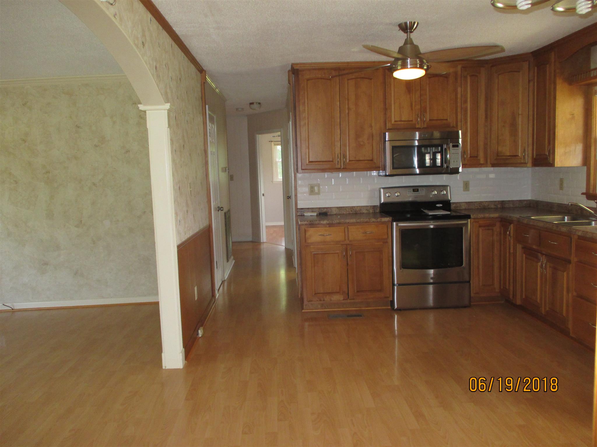 1089 Fall River Road Goodspring, TN 38460 - Photo 5 of 24 a kitchen with stainless steel appliances granite countertop a stove a sink and a refrigerator