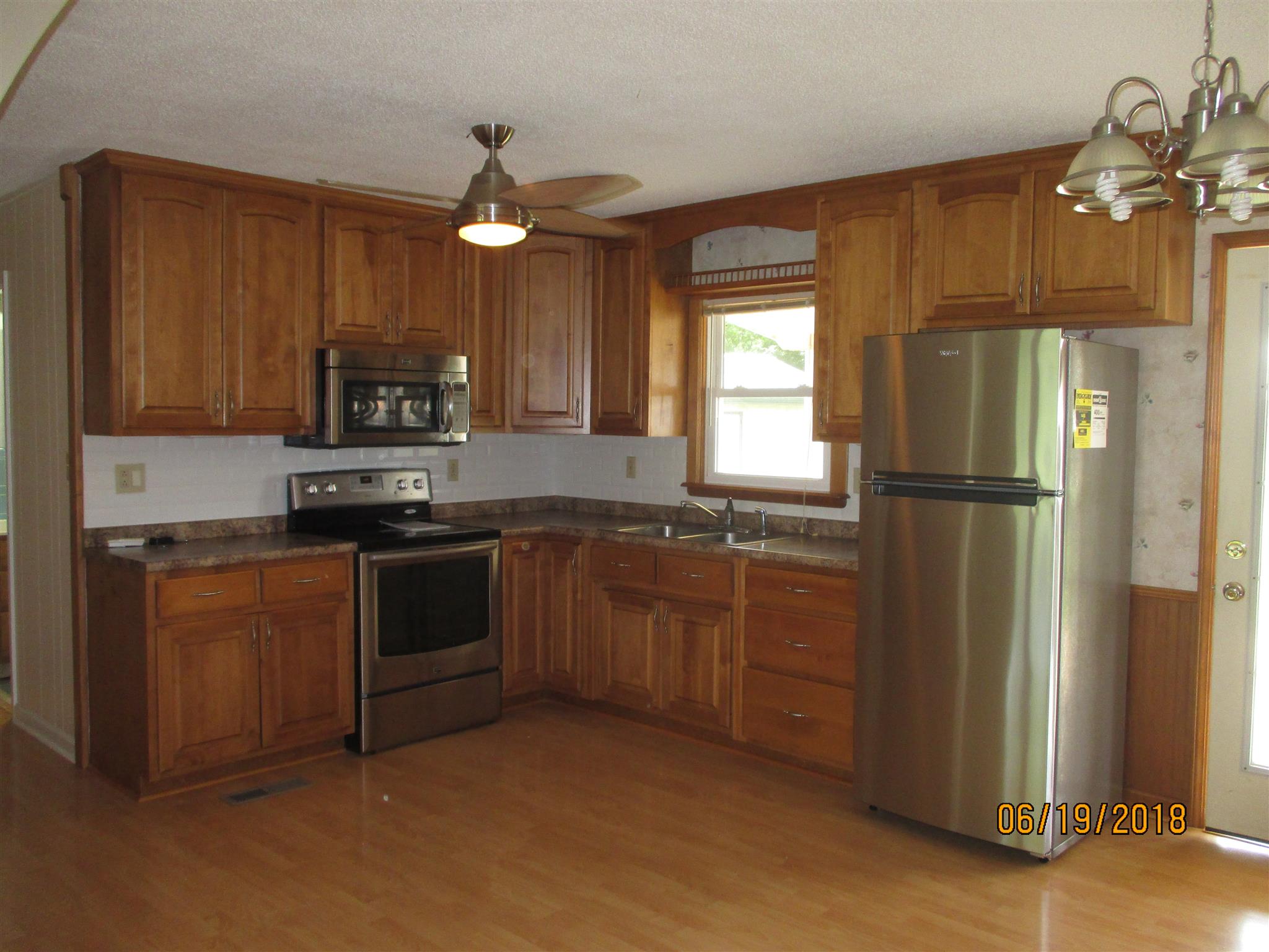 1089 Fall River Road Goodspring, TN 38460 - Photo 6 of 24 a kitchen with stainless steel appliances granite countertop a refrigerator a stove a sink and dishwasher