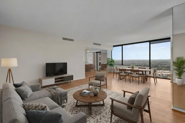 a view of a dining room with furniture and a potted plant