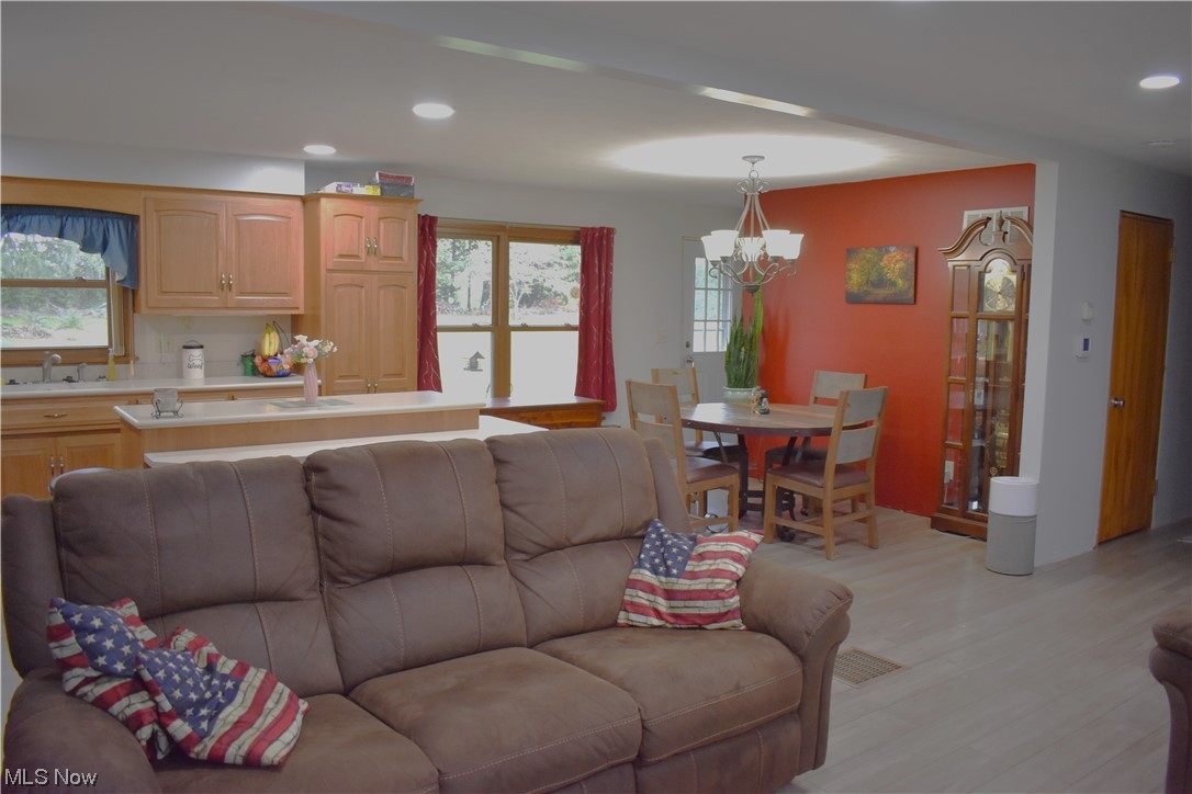 1597 South Funk Road Wooster, OH 44691 - Photo 5 of 35 Living room featuring plenty of natural light, a notable chandelier, sink, and light hardwood floors
