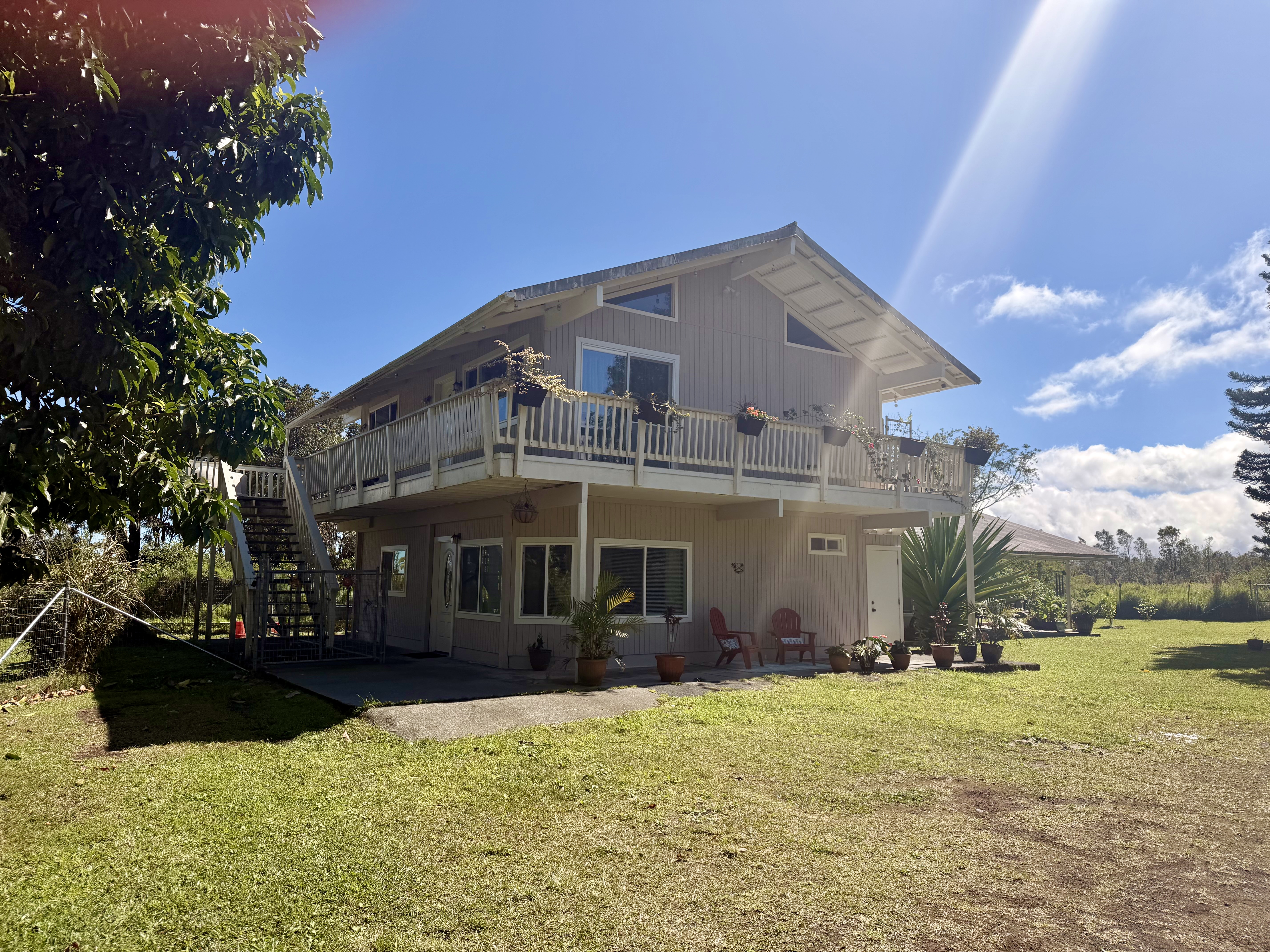 11-2485 Omeka Road Mountain View, HI 96771 - Photo 4 of 30 a front view of a building with a garden