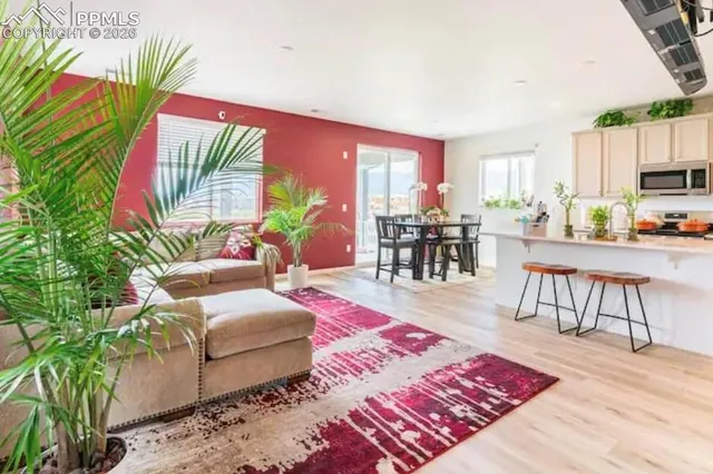 a living room with furniture and a wooden floor