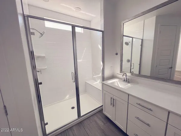 a bathroom with a sink double vanity and a mirror