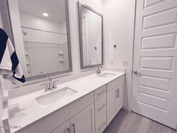 a bathroom with a shower sink and mirror