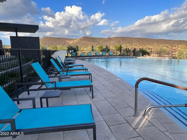 a swimming pool with outdoor seating and yard