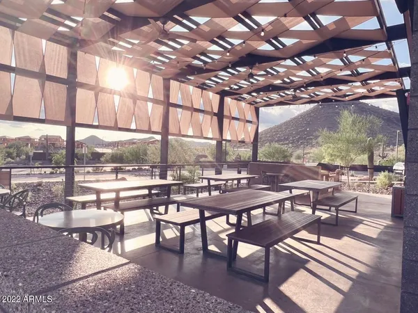 a living room with furniture kitchen view and a large window